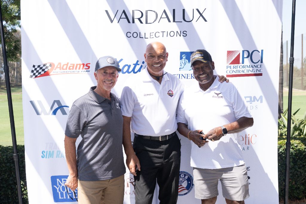 Baja 1000 legends Steven Buckley and Felix Giles with Raiders legend Greg Townsend at the sponsor backdrop