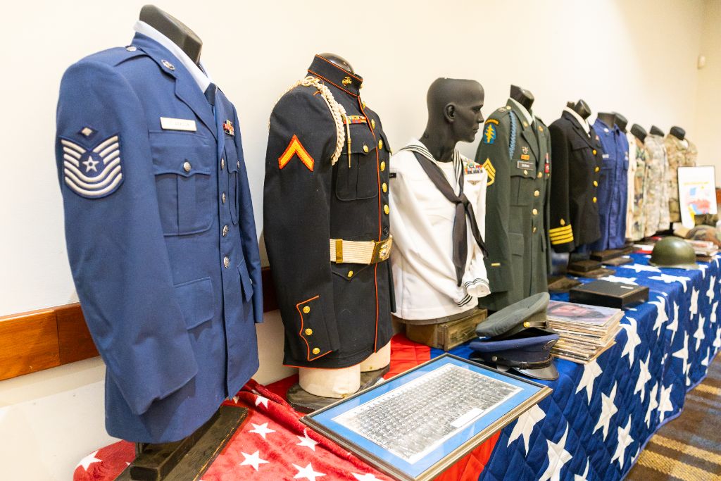 Military service uniforms from every U.S. branch displayed on mannequins in the banquet hall
